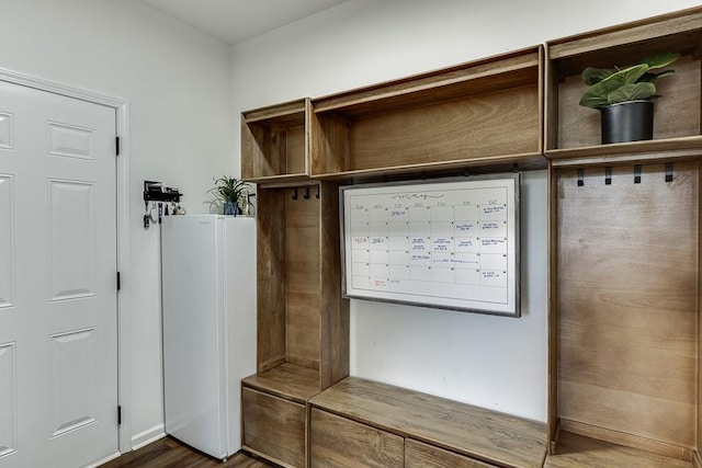 mudroom with dark wood-style floors
