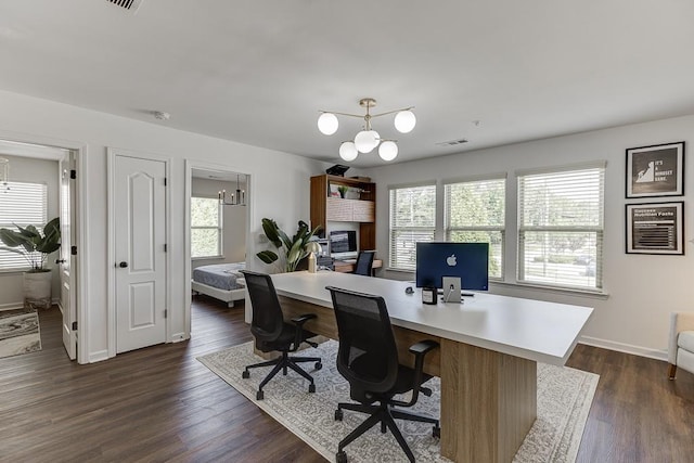 home office with a chandelier, plenty of natural light, dark wood finished floors, and baseboards