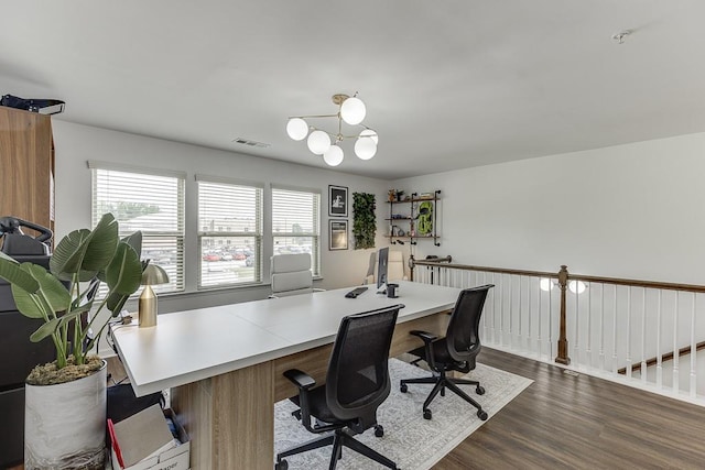 office with dark wood-style flooring and a chandelier