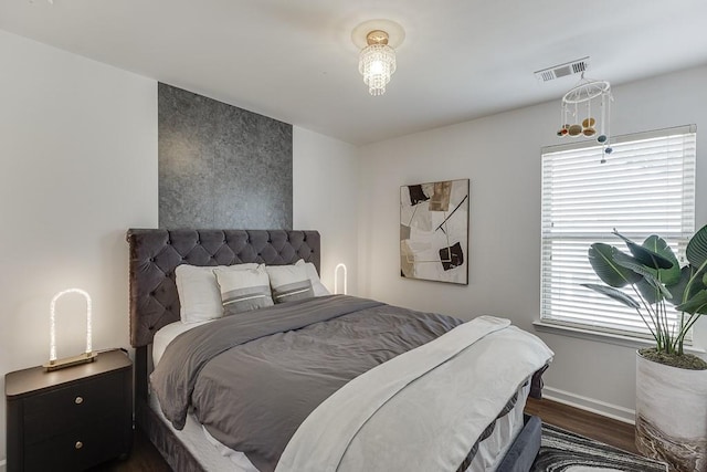 bedroom with dark wood finished floors and baseboards