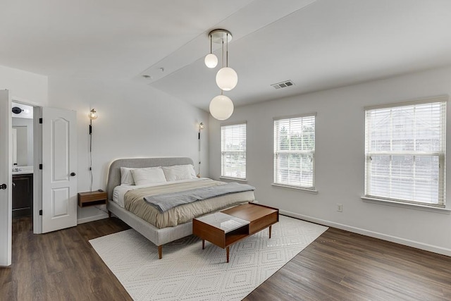 bedroom featuring dark wood-type flooring, vaulted ceiling, and baseboards