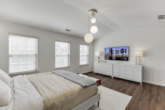 bedroom featuring lofted ceiling, dark wood-type flooring, and baseboards