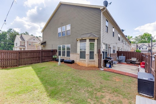back of house with a patio and brick siding