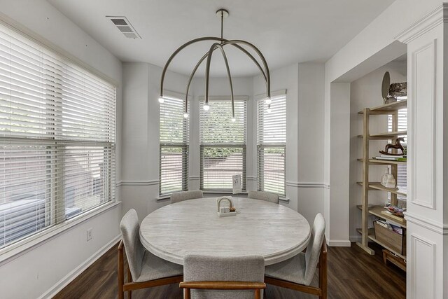 dining room featuring wood finished floors, baseboards, and plenty of natural light
