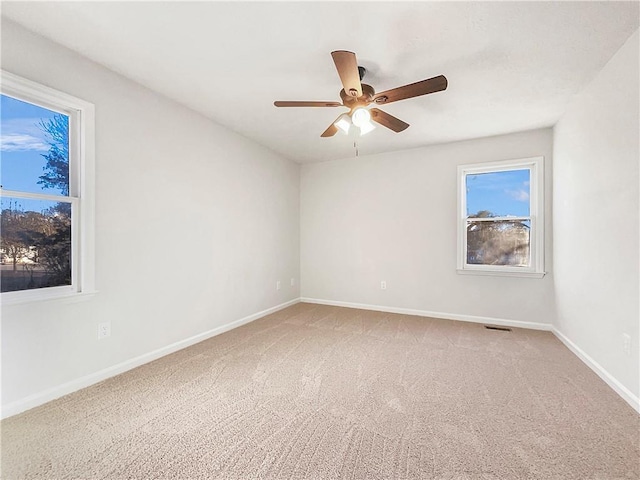 spare room with ceiling fan and carpet flooring