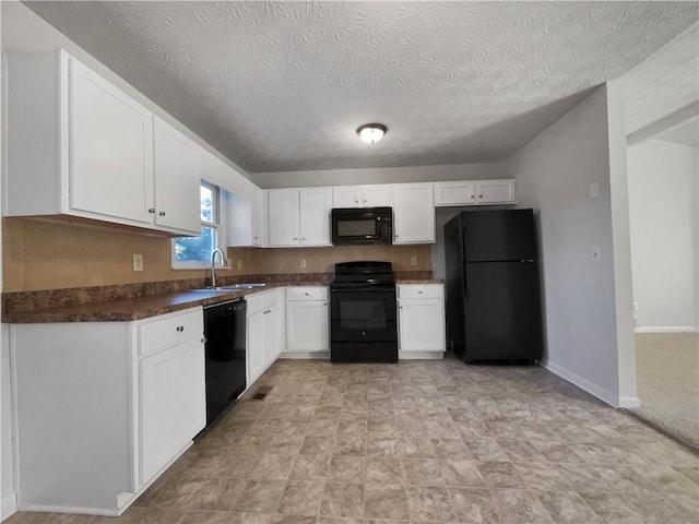 kitchen featuring sink, white cabinetry, black appliances, and a textured ceiling