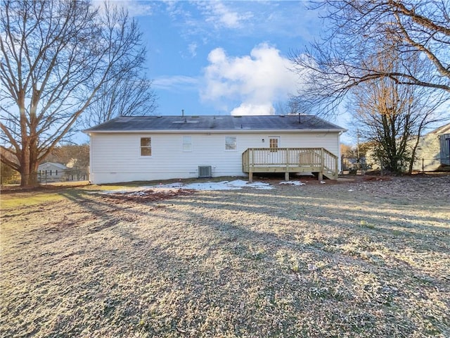 rear view of property featuring central AC and a wooden deck