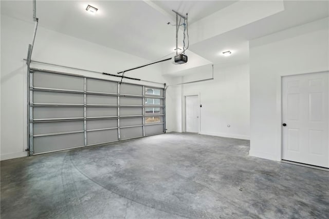 garage with baseboards and a garage door opener