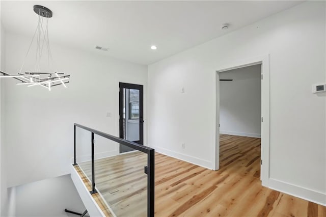 corridor with baseboards, recessed lighting, visible vents, and light wood-style floors