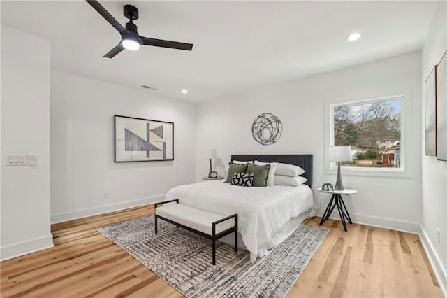 bedroom featuring baseboards, light wood-type flooring, visible vents, and recessed lighting