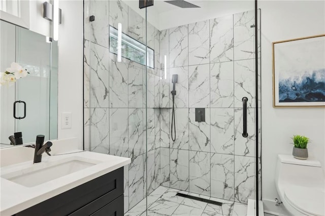 full bathroom featuring marble finish floor, vanity, a marble finish shower, and toilet