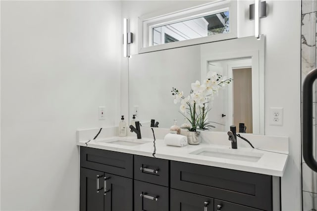 full bathroom with double vanity and a sink