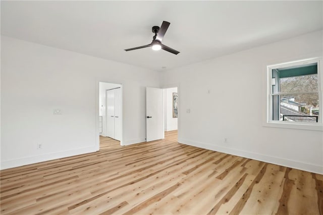 unfurnished bedroom featuring a ceiling fan, light wood-style flooring, and baseboards