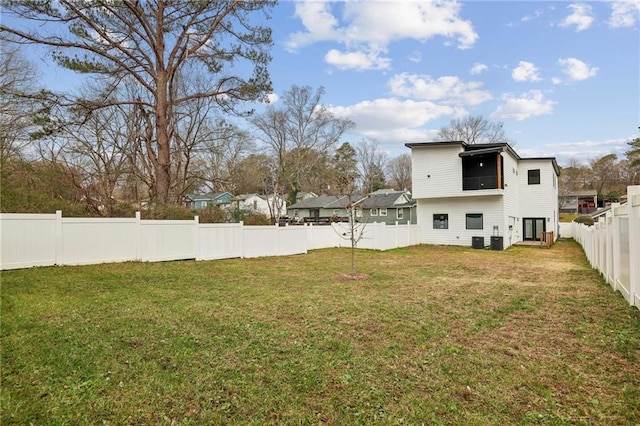 view of yard featuring central AC unit and a fenced backyard