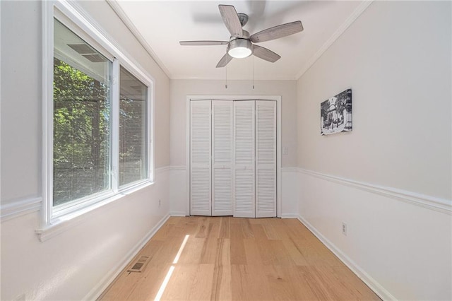 1402 Mclendon Dr, Decatur, GA 30033 - unfurnished bedroom with light wood-style flooring, ornamental molding, a closet, and a ceiling fan