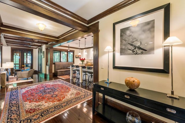 interior space featuring french doors, ornamental molding, dark wood-type flooring, coffered ceiling, and beamed ceiling