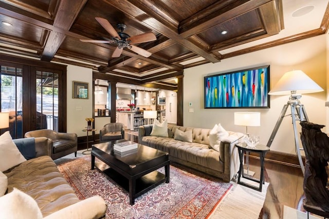 living area featuring beam ceiling, coffered ceiling, light wood-style flooring, and crown molding