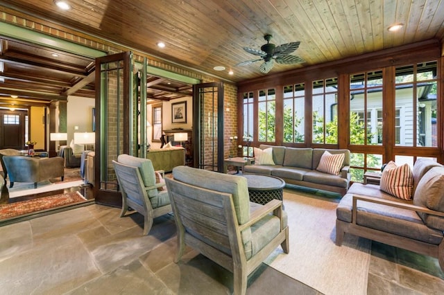 living area with wooden ceiling, recessed lighting, brick wall, a ceiling fan, and stone finish flooring