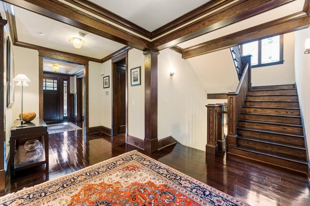 entryway with dark wood-style flooring, decorative columns, ornamental molding, baseboards, and stairs