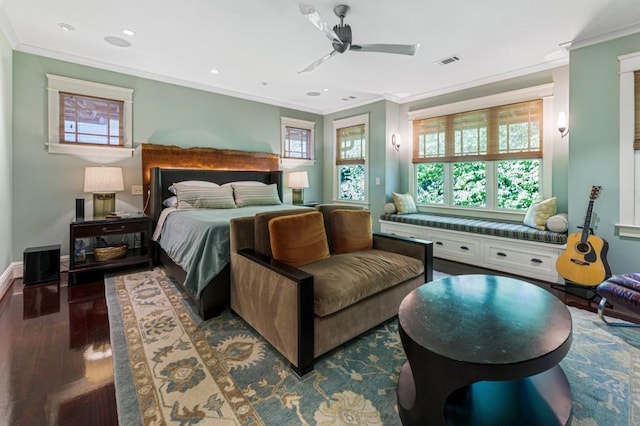 bedroom featuring multiple windows, visible vents, wood finished floors, and ornamental molding