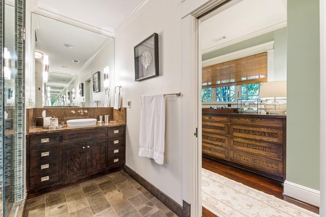 full bathroom with baseboards, decorative backsplash, ornamental molding, stone finish flooring, and vanity