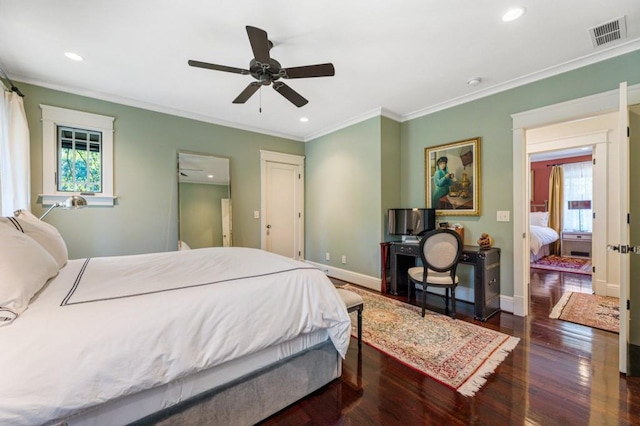 bedroom with ornamental molding, visible vents, dark wood finished floors, and baseboards