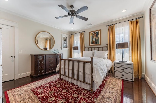 bedroom featuring ornamental molding, dark wood-style flooring, visible vents, and baseboards