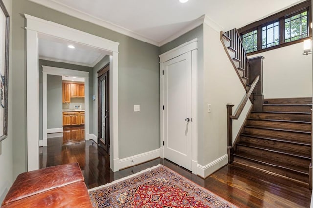 foyer entrance featuring baseboards, stairway, dark wood-style flooring, crown molding, and recessed lighting