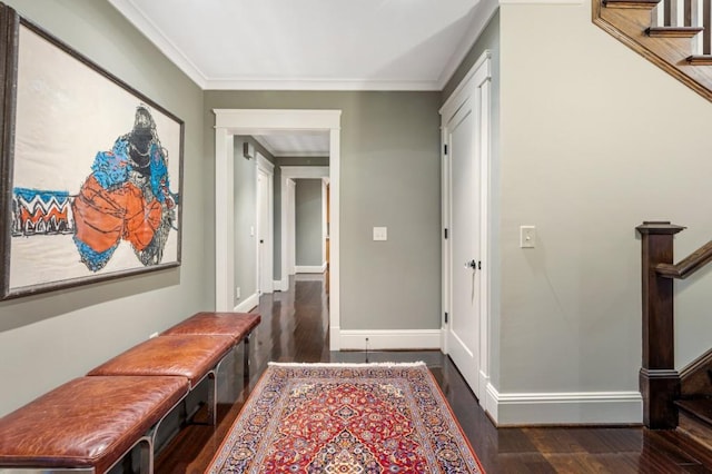 hallway with dark wood-style floors, crown molding, stairway, and baseboards