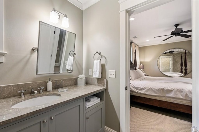 bathroom with ornamental molding, connected bathroom, vanity, and ceiling fan