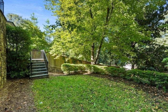 view of yard featuring stairway and fence