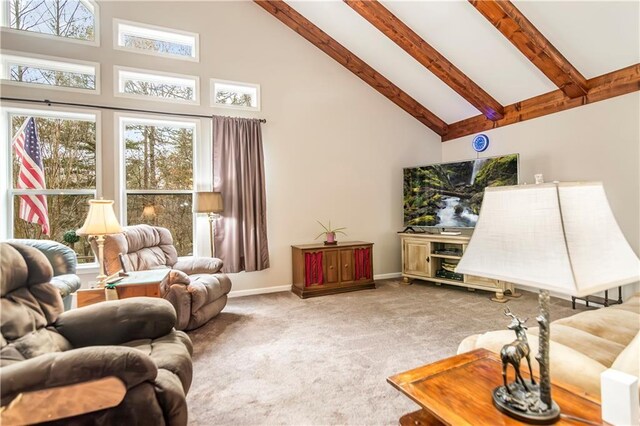 living room featuring beam ceiling, ceiling fan with notable chandelier, a high ceiling, and carpet flooring