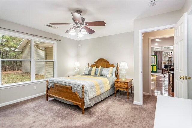 bedroom featuring ceiling fan and light carpet