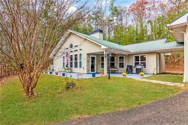 rear view of property featuring a yard