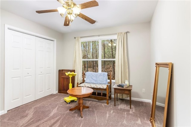 sitting room with carpet and ceiling fan