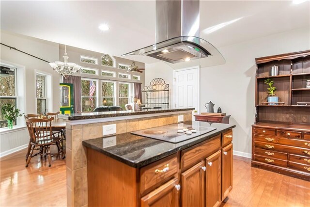 kitchen with island range hood, stainless steel appliances, a center island, a breakfast bar, and sink