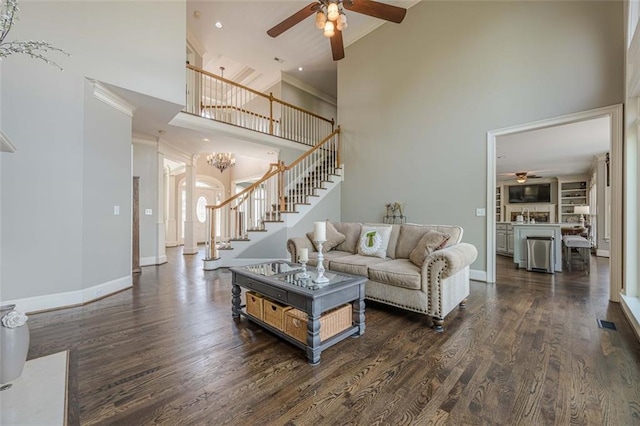 living room with baseboards, stairs, a ceiling fan, and dark wood-style flooring