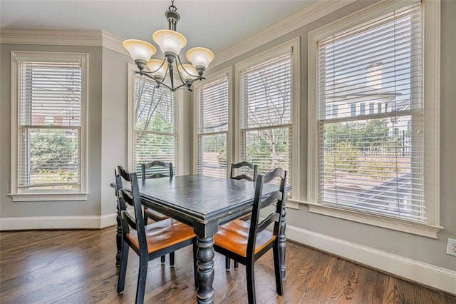 dining space featuring dark wood finished floors, an inviting chandelier, plenty of natural light, and baseboards