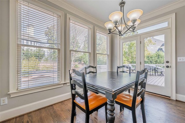 dining space with a chandelier, a healthy amount of sunlight, baseboards, and wood finished floors