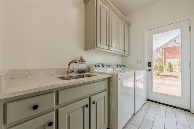 laundry area with a sink, cabinet space, and washer and dryer