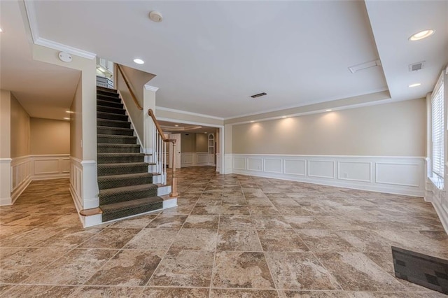 interior space with visible vents, a wainscoted wall, recessed lighting, stairway, and a decorative wall