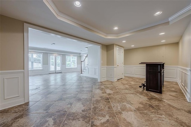 interior space featuring stairway, a tray ceiling, recessed lighting, ornamental molding, and wainscoting