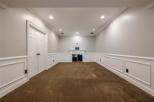 interior space featuring recessed lighting, dark carpet, a decorative wall, and ornamental molding