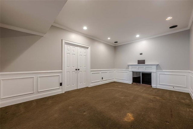 interior space featuring a decorative wall, recessed lighting, and dark colored carpet