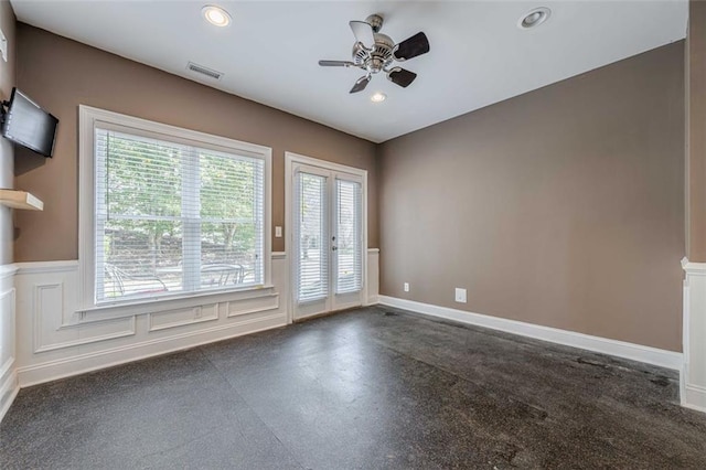 spare room featuring recessed lighting, a wainscoted wall, a ceiling fan, and a decorative wall