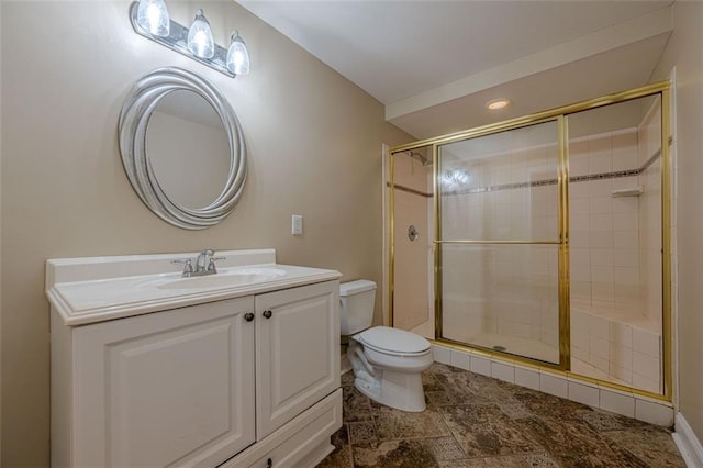 bathroom with vanity, a shower stall, and toilet