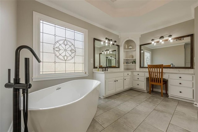 full bathroom with built in features, a freestanding tub, ornamental molding, and vanity