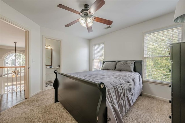 bedroom featuring visible vents, multiple windows, light colored carpet, and baseboards