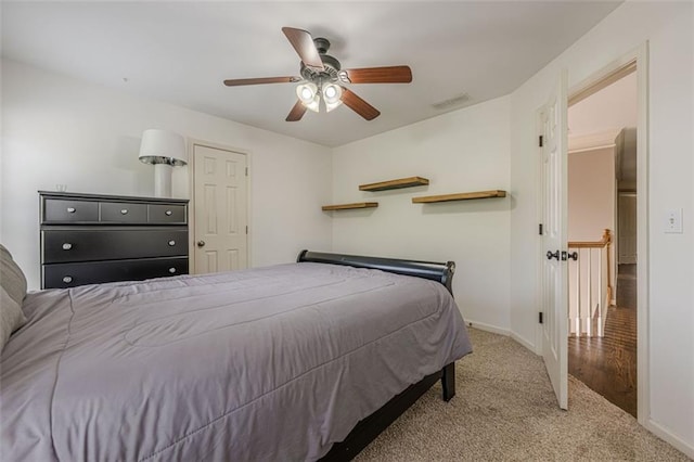 carpeted bedroom featuring visible vents, a ceiling fan, and baseboards