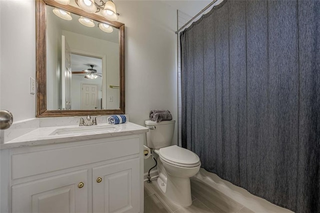 bathroom with toilet, vanity, a shower with curtain, and ceiling fan